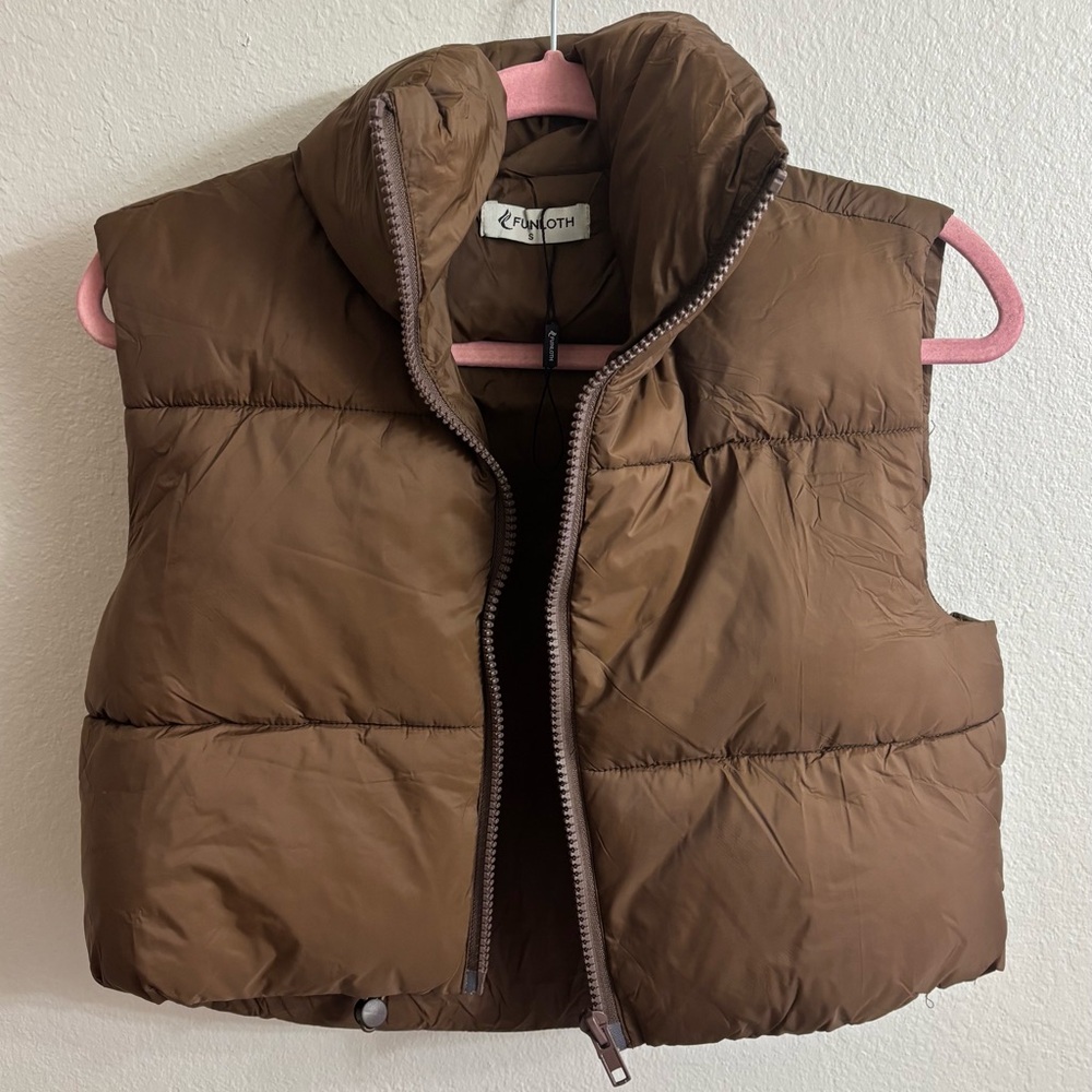 Small, cropped, brown puffer vest.